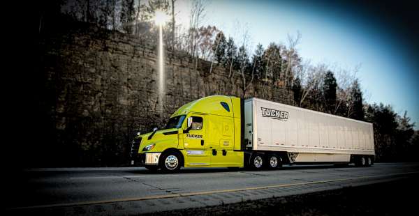 Truck Driver standing next to Semi Tractor