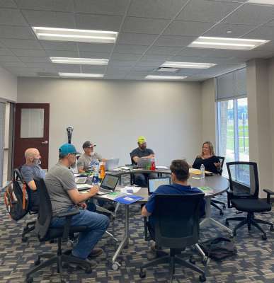 A group of people meeting at the What to Expect During Driver Orientation at Tucker Freight Lines event.