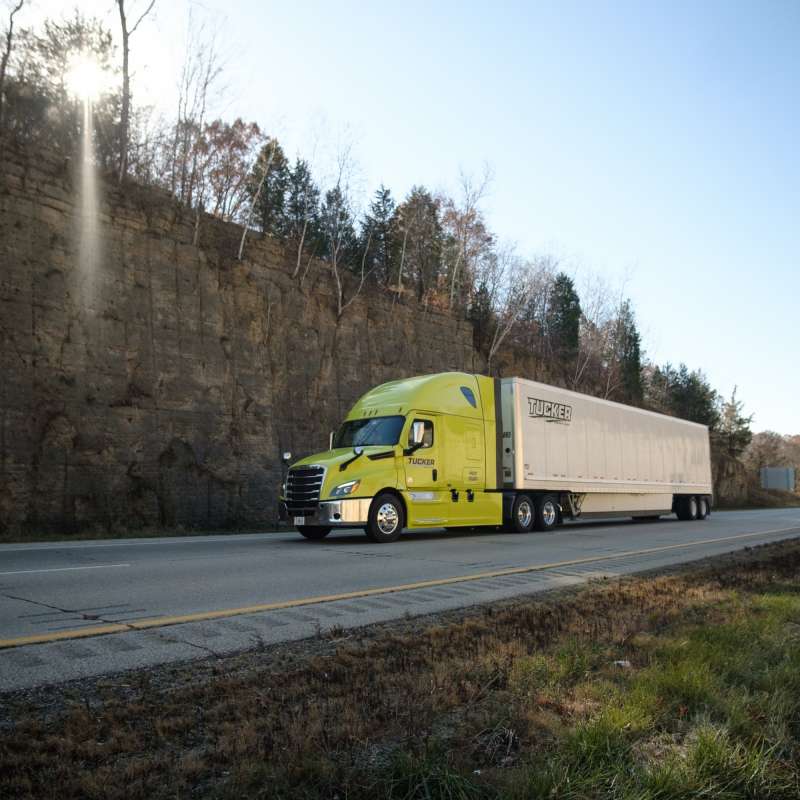 Tucker Freight Lines truck driving on scenic road